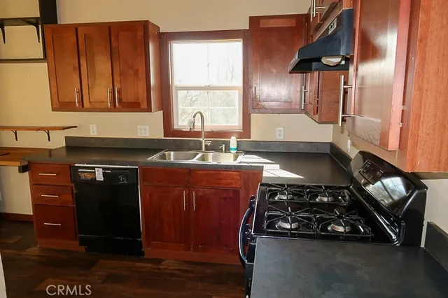 a kitchen with wooden cabinets and a stove top oven