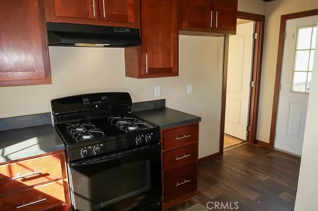 a kitchen with stainless steel appliances granite countertop a stove and a microwave