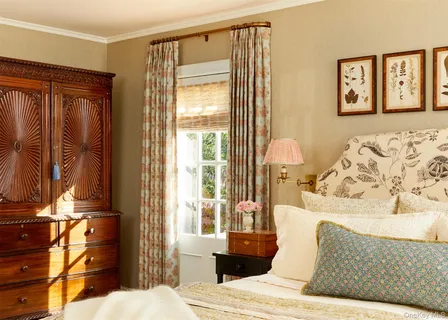 a bedroom with a bed window and a dresser