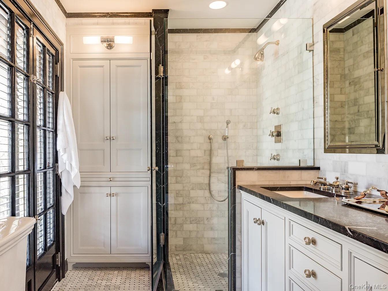 86 Pondfield Road West Bronxville, NY 10708 - Photo 19 of 30 a bathroom with a granite countertop sink and a shower