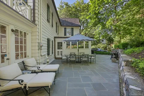 a view of a patio with table and chairs and potted plants
