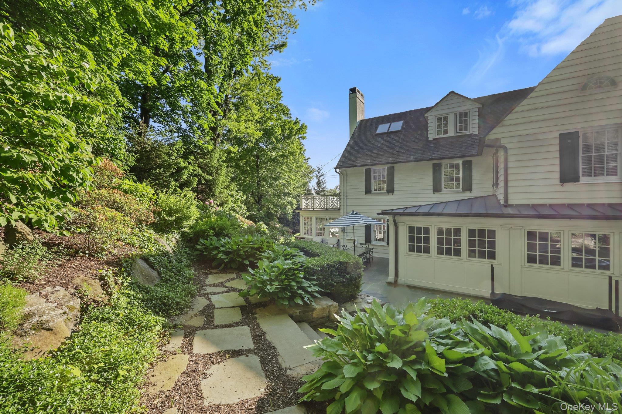 86 Pondfield Road West Bronxville, NY 10708 - Photo 28 of 30 a front view of a house with a garden
