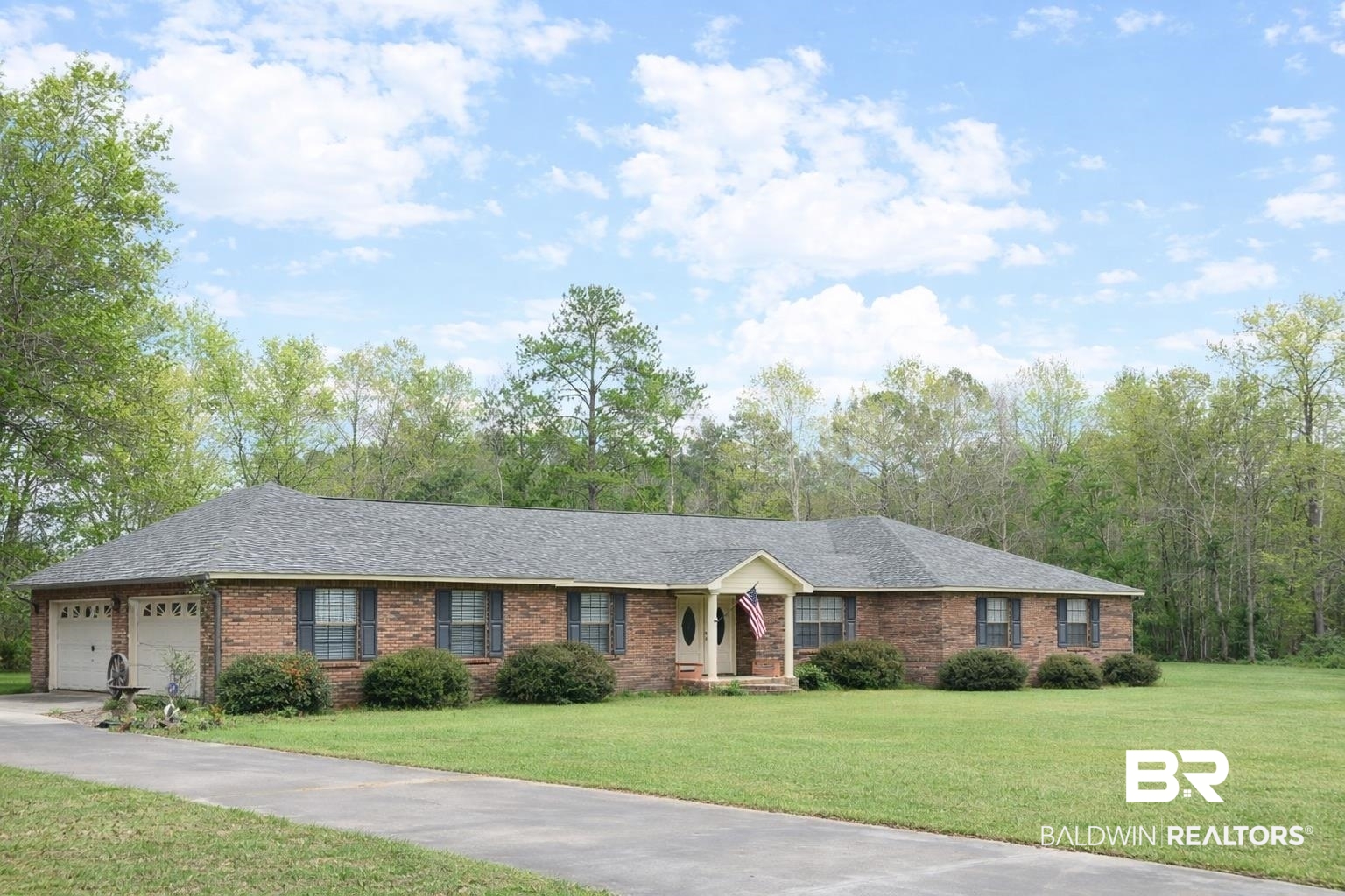 2538 Old Castleberry Road Brewton, AL 36426 - Photo 12 of 12 Ranch-style house with brick siding, a front yard, an attached garage, driveway, and a shingled roof