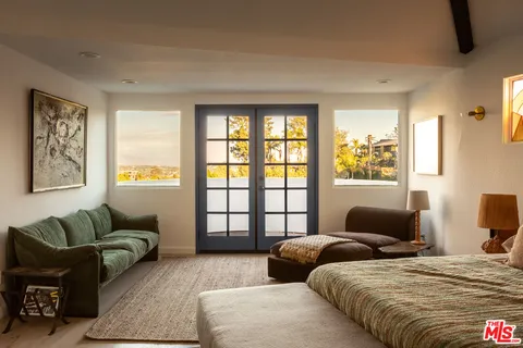 a bedroom with two beds and a couch