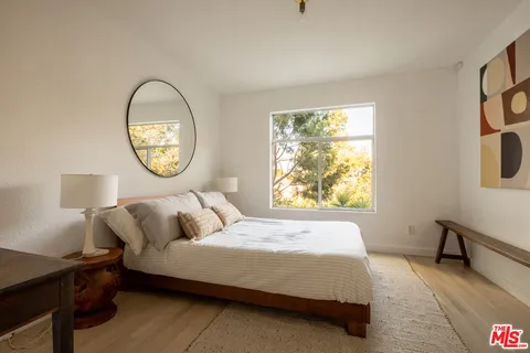 a bedroom with bed and window