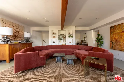 a living room with furniture a rug and a flat screen tv