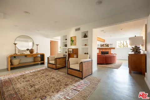 a bedroom with furniture and a wooden floor