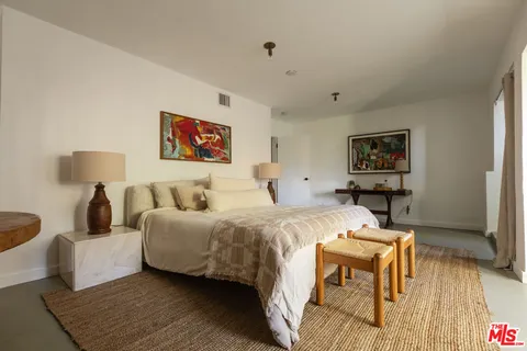 a bed room with a bed and a night stand