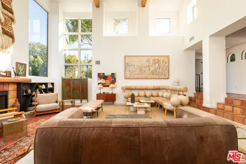 a bedroom with furniture and a large window