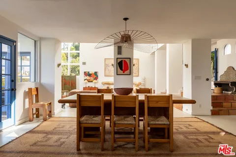 a dining room with furniture window and wooden floor