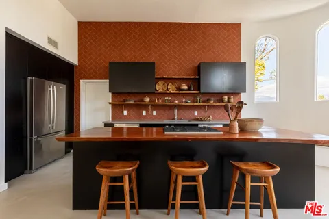 a kitchen with a table and chairs