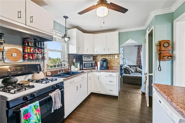 a kitchen with stainless steel appliances granite countertop a stove and cabinets