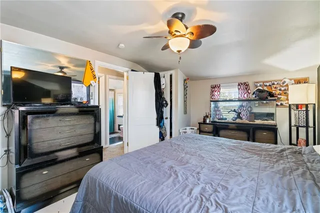 a bedroom with a bed and a flat screen tv