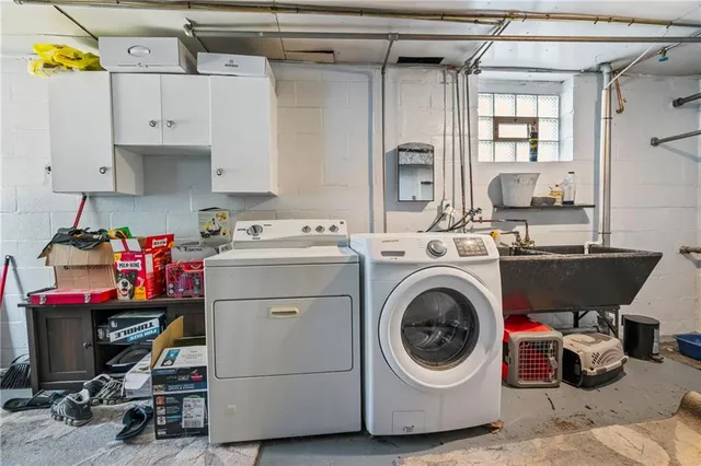 a utility room with cabinets dryer and washer