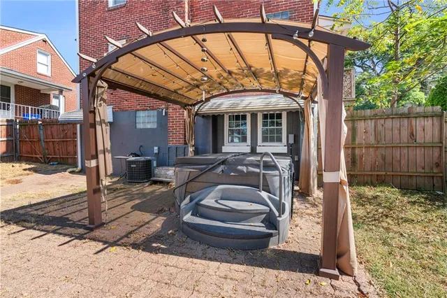aerial view of a house with a yard and a large tree