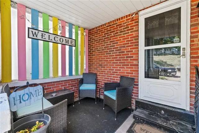 a view of a brick house with large windows