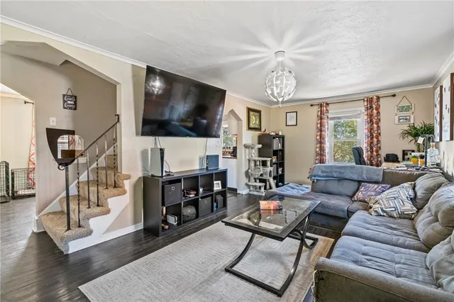 a living room with furniture a flat screen tv and a large window