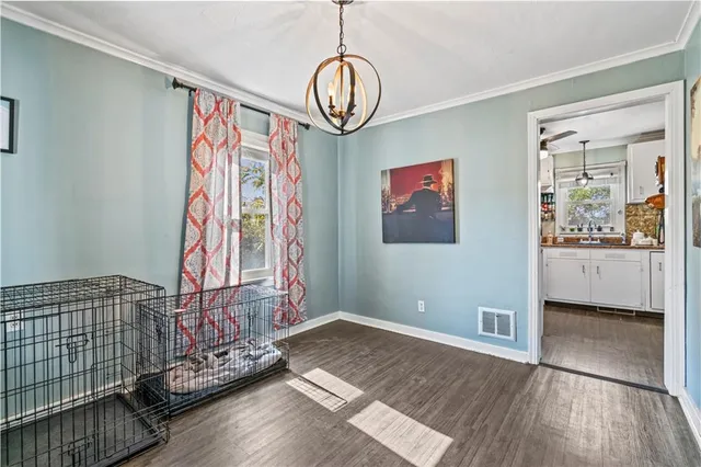 a view of a room with wooden floor and window