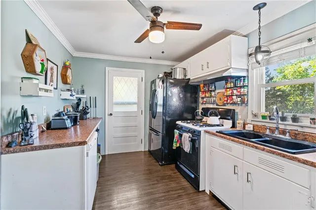 a kitchen that has a lot of cabinets and refrigerator