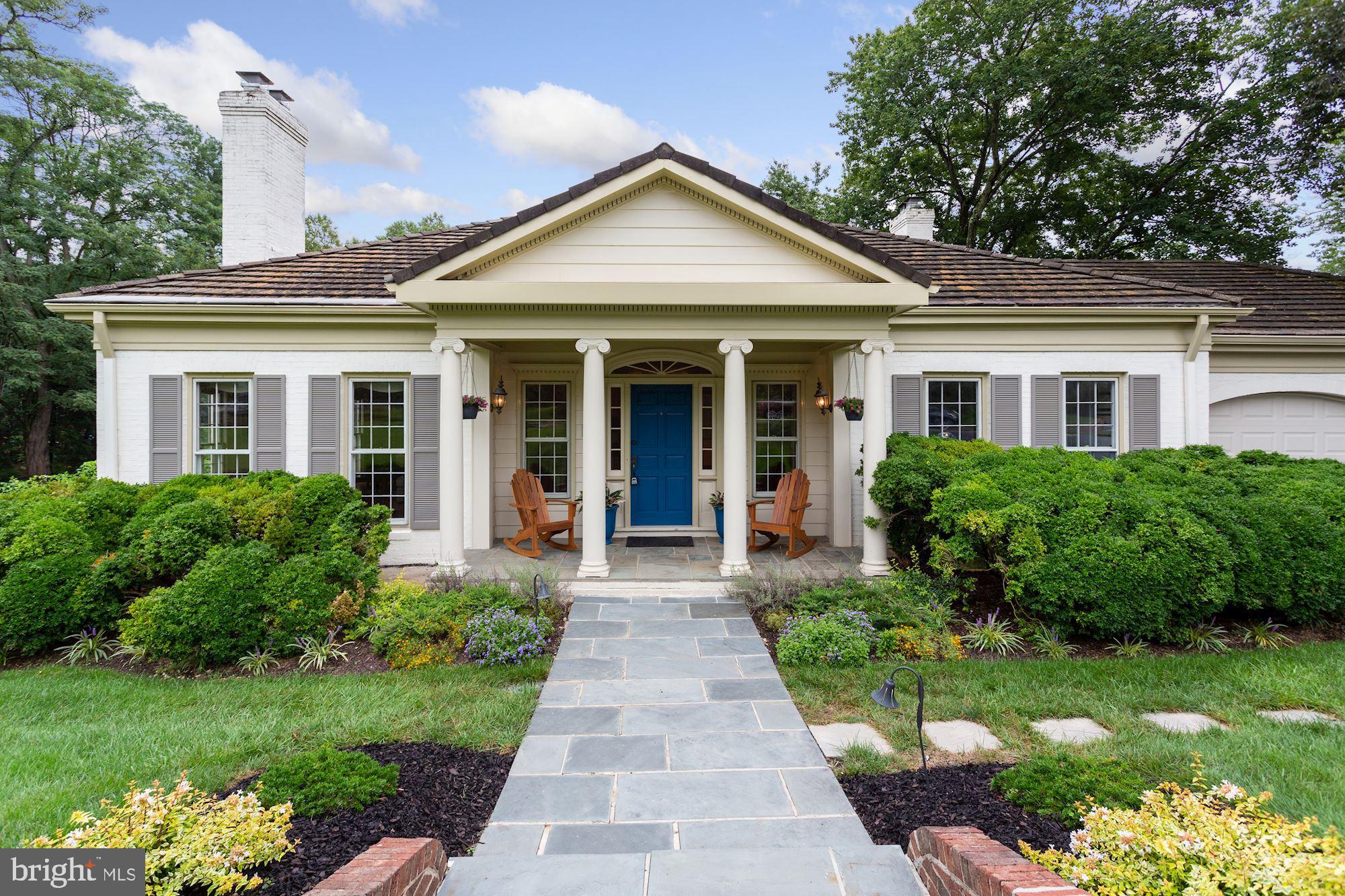 1311 Merrie Ridge Road McLean, VA 22101 - Photo 1 of 54 a front view of a house with a yard and potted plants