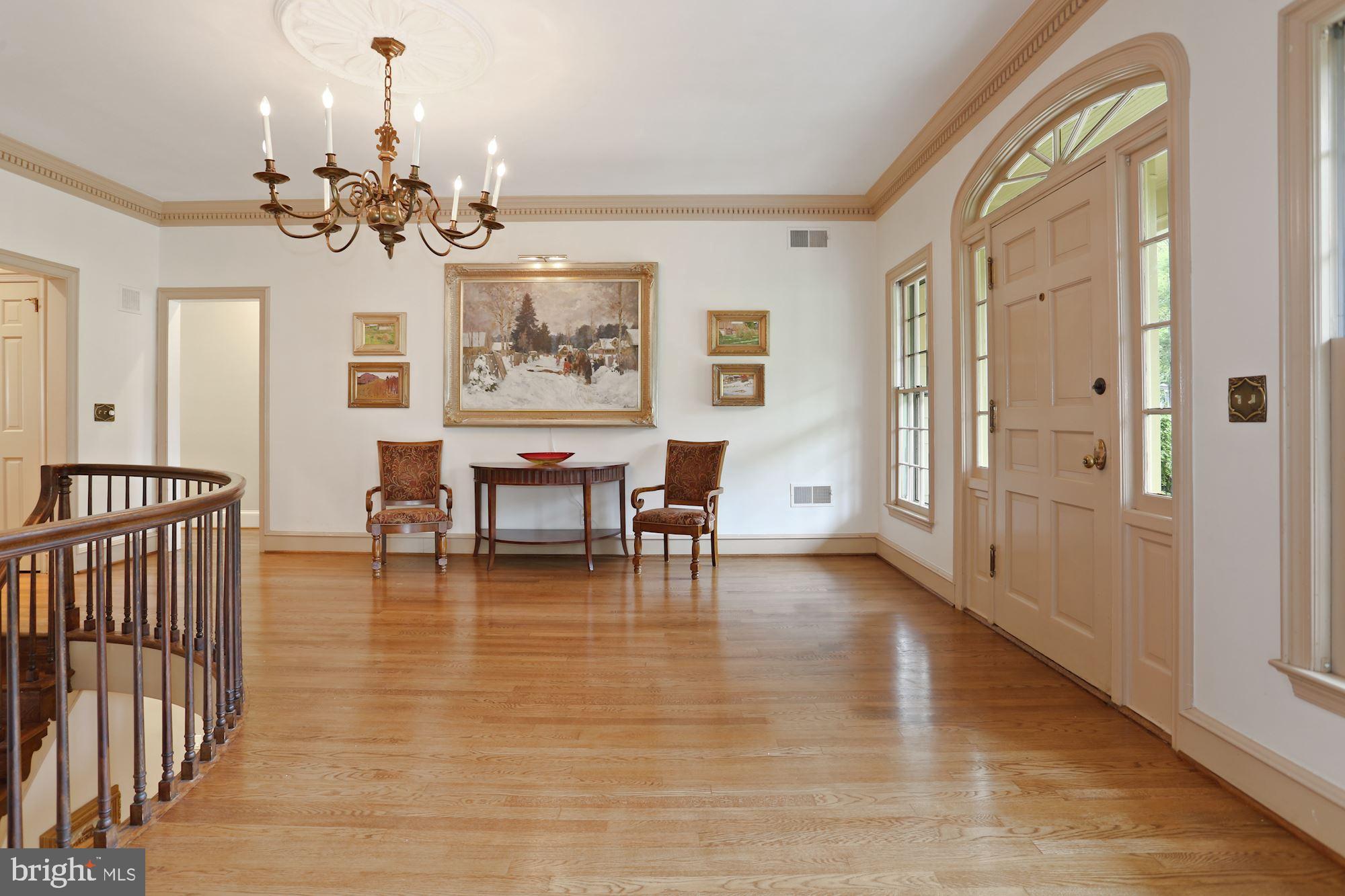 1311 Merrie Ridge Road McLean, VA 22101 - Photo 3 of 54 a view of a dining room with furniture a chandelier and wooden floor