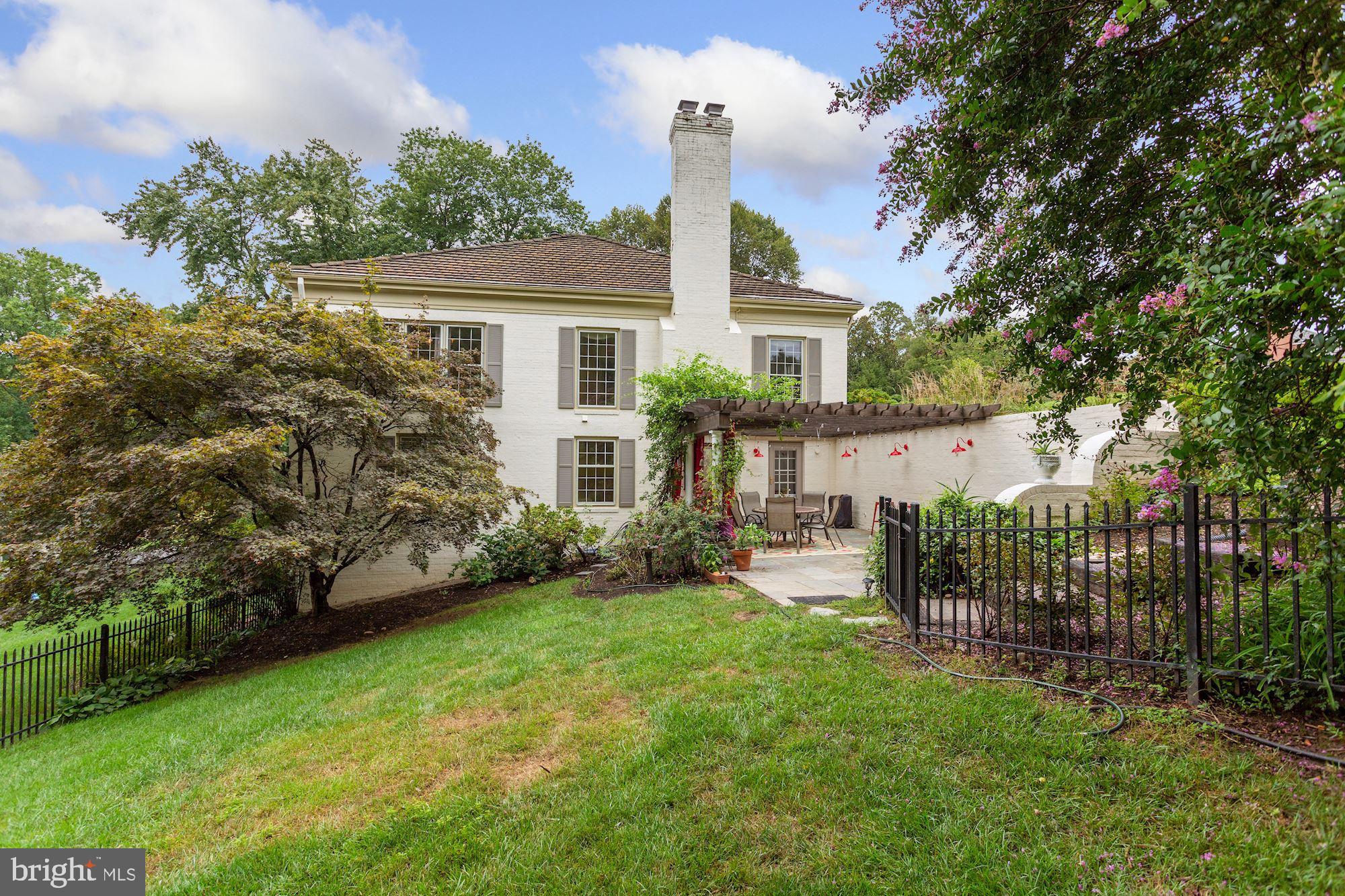 1311 Merrie Ridge Road McLean, VA 22101 - Photo 50 of 54 a front view of a house with a garden and yard