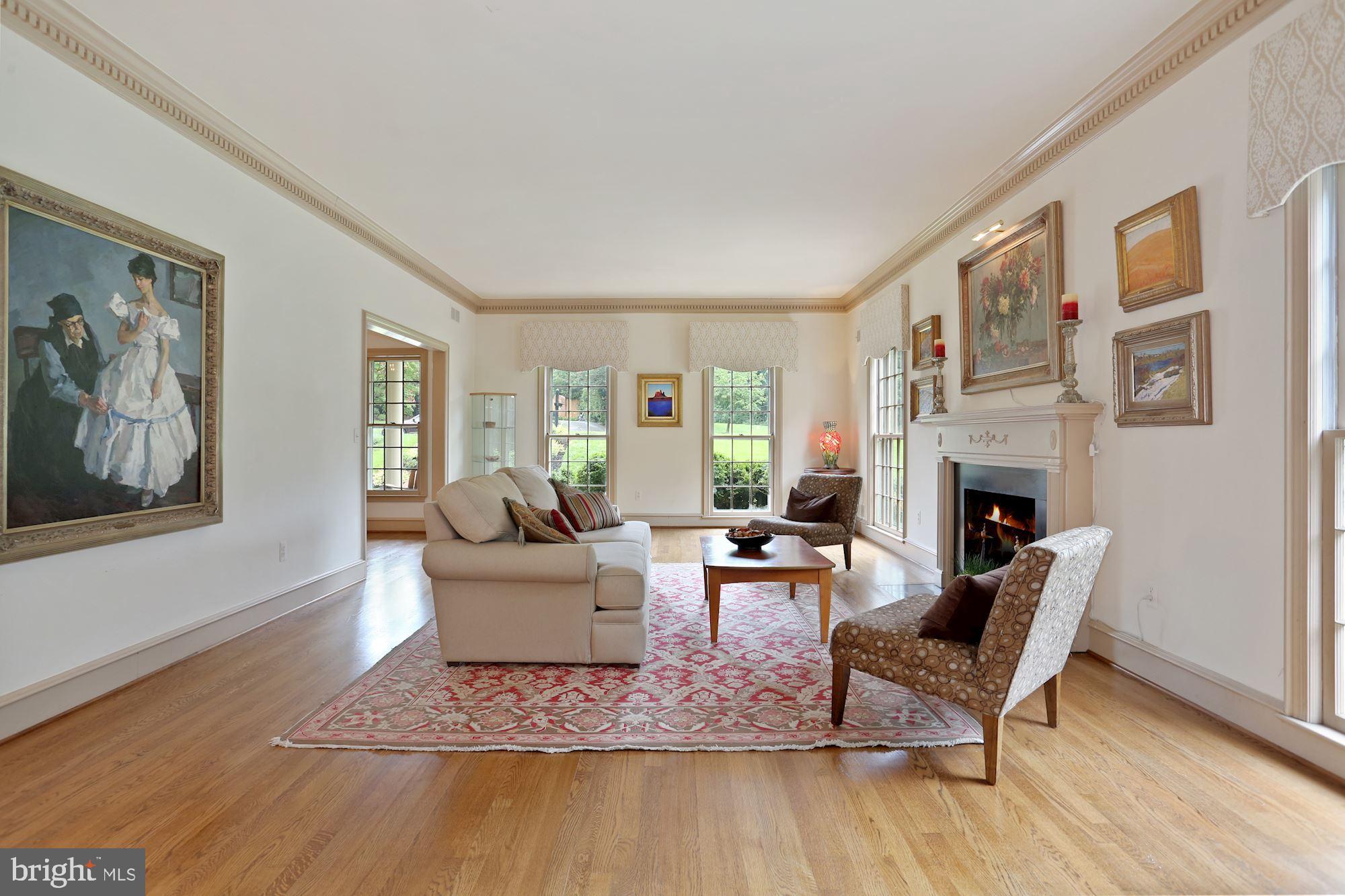 1311 Merrie Ridge Road McLean, VA 22101 - Photo 7 of 54 a living room with furniture a fireplace and a window