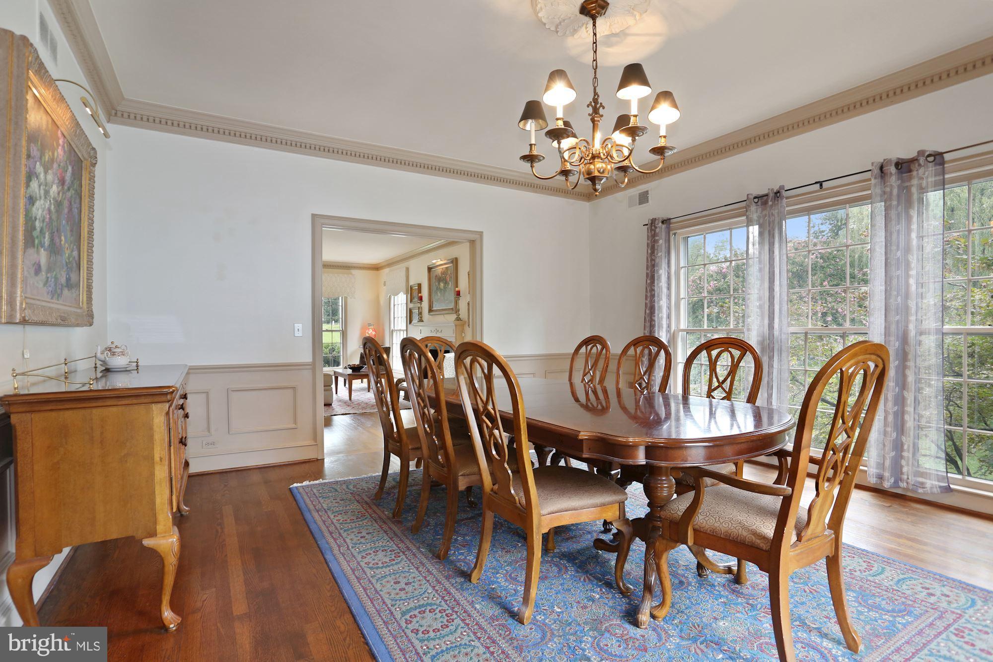 1311 Merrie Ridge Road McLean, VA 22101 - Photo 8 of 54 a dining room with furniture a chandelier and wooden floor