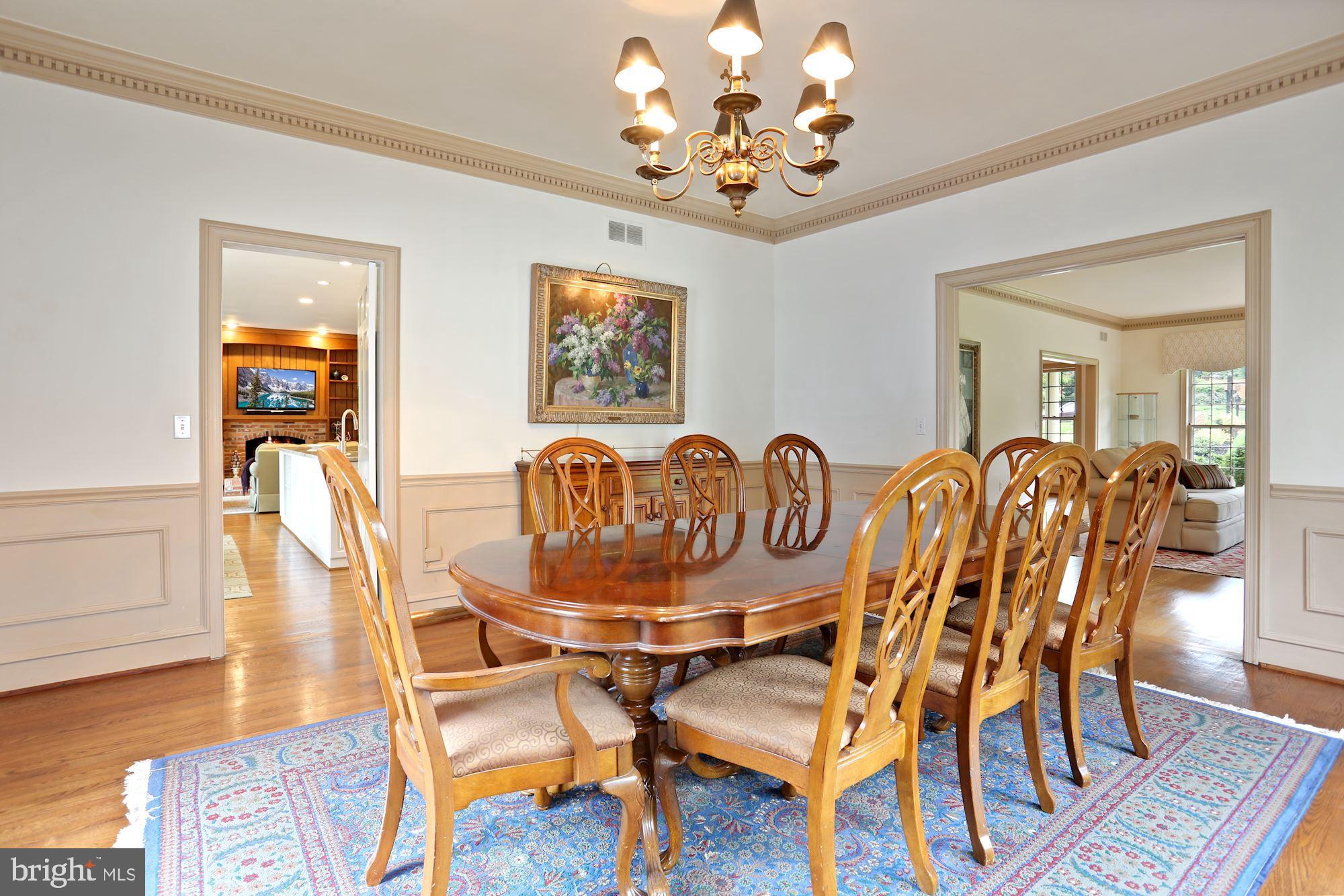 1311 Merrie Ridge Road McLean, VA 22101 - Photo 9 of 54 a view of a dining room with furniture wooden floor and chandelier