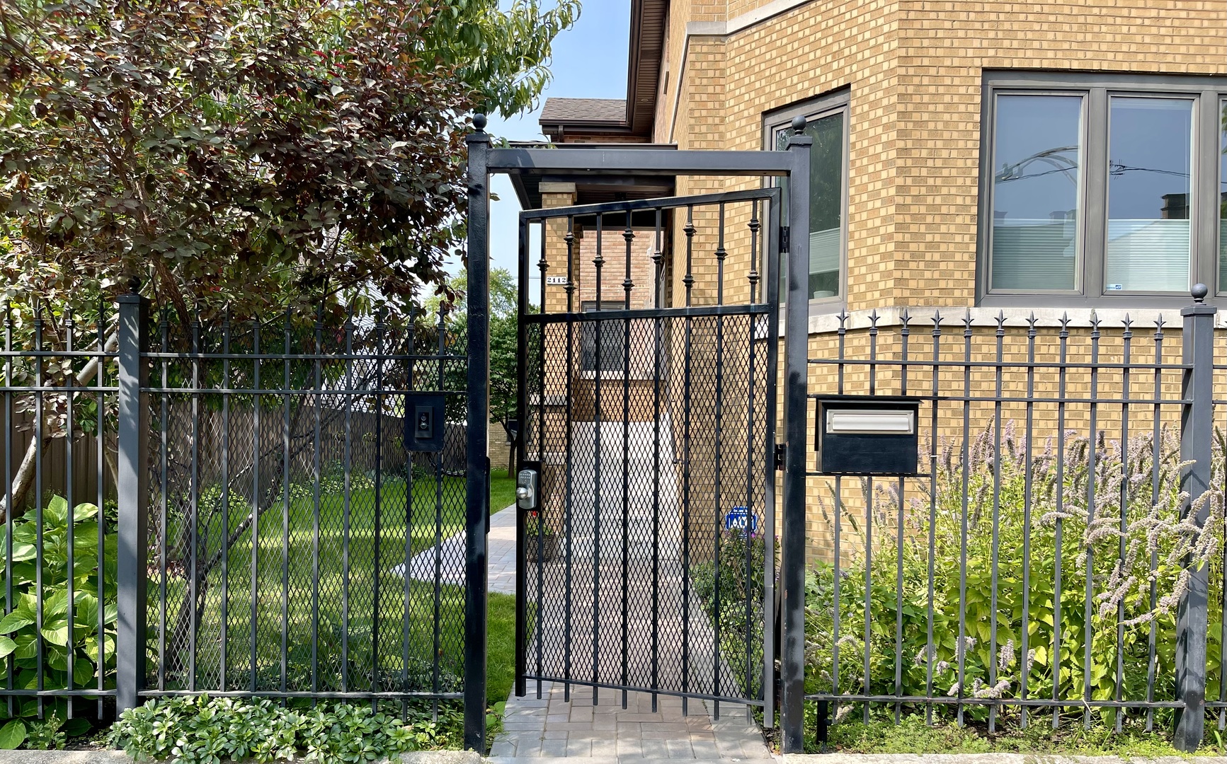 2112 North Sawyer Avenue, Unit I Chicago, IL 60647 - Photo 1 of 30 a view of a house with a small yard and wooden fence