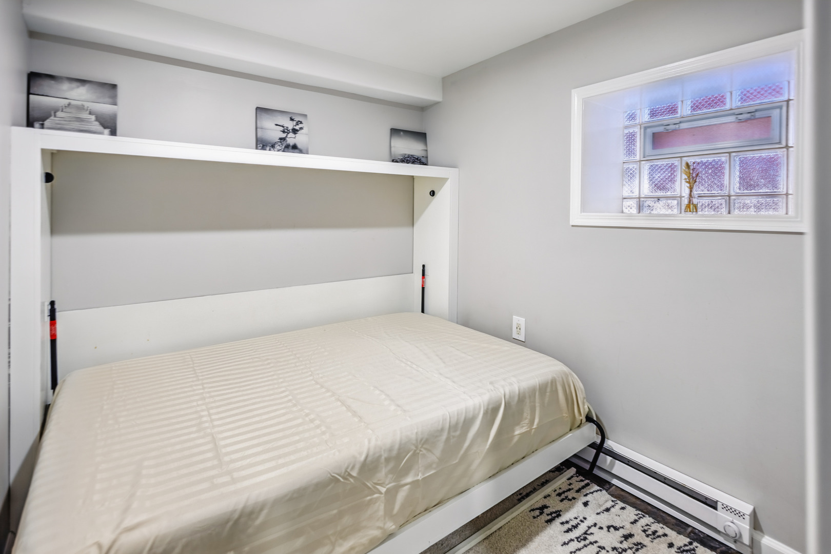 2112 North Sawyer Avenue, Unit I Chicago, IL 60647 - Photo 11 of 30 a bedroom with a bed and a window