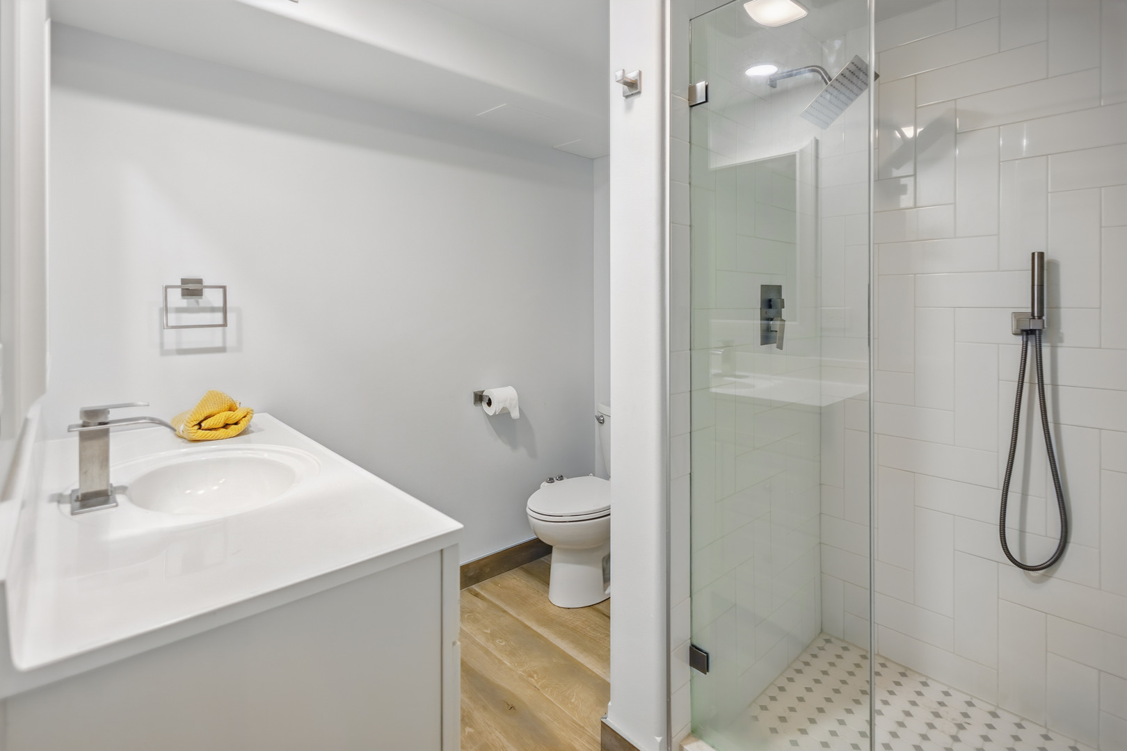 2112 North Sawyer Avenue, Unit I Chicago, IL 60647 - Photo 22 of 30 a bathroom with a granite countertop sink a toilet and shower