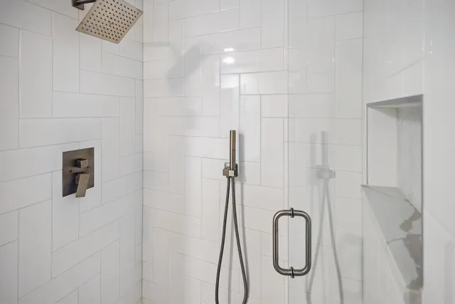 a bathroom with a granite countertop shower and a sink