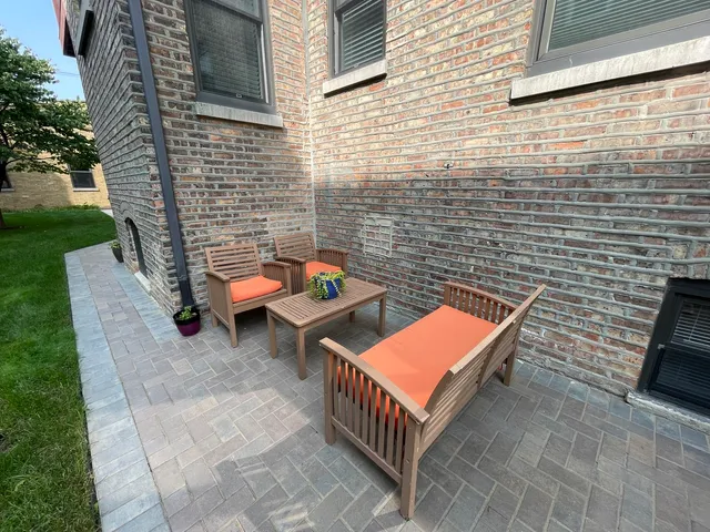 a backyard of a house with chairs and a fire pit