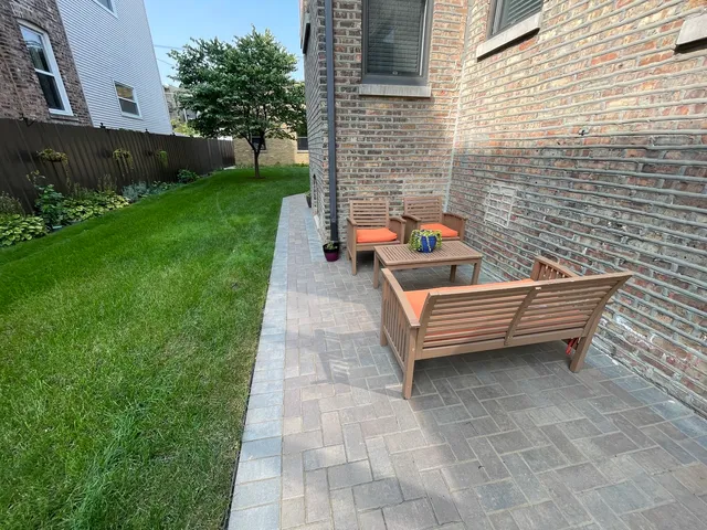 a backyard of a house with outdoor seating