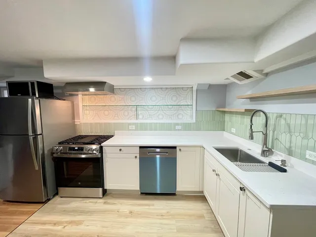 a kitchen with a sink and a refrigerator