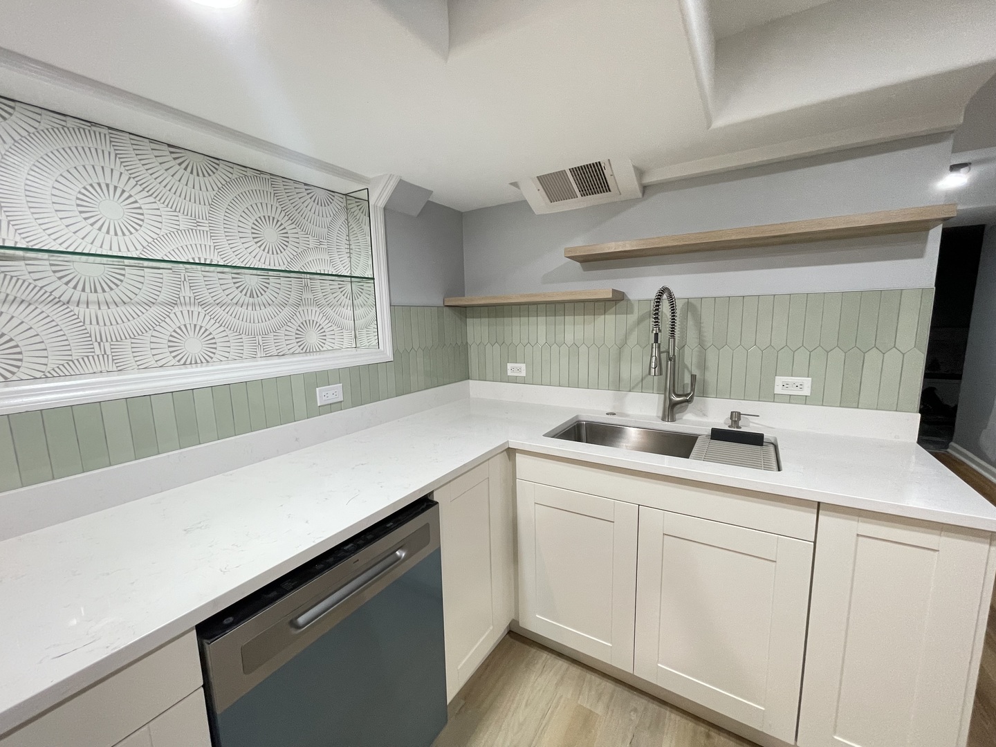 2112 North Sawyer Avenue, Unit I Chicago, IL 60647 - Photo 6 of 30 a kitchen with white cabinets and sink