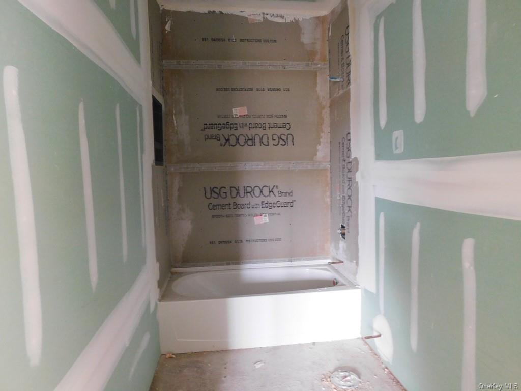90 Quaker Street Wallkill, NY 12589 - Photo 10 of 19 Bathroom featuring concrete floors and a bath