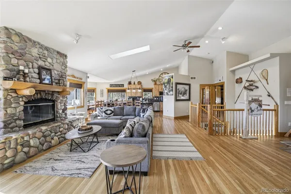 a living room with furniture a fireplace and a flat screen tv