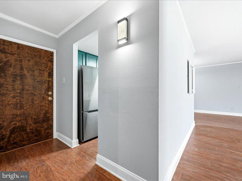 421 Drummers Lane, Unit 421 Wayne, PA 19087 - Photo 12 of 30 a view of a hallway with wooden floor and a bathroom