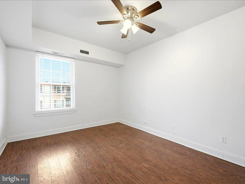 421 Drummers Lane, Unit 421 Wayne, PA 19087 - Photo 18 of 30 wooden floor in an empty room with a window