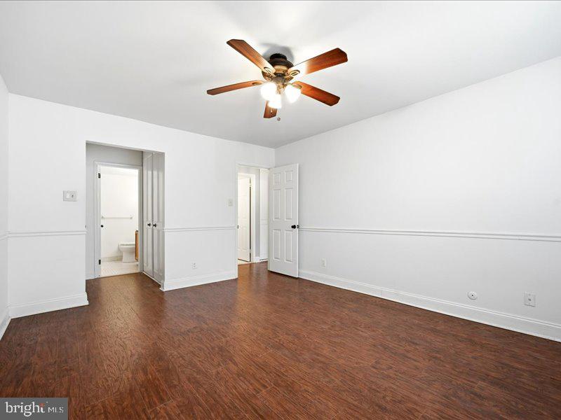 421 Drummers Lane, Unit 421 Wayne, PA 19087 - Photo 22 of 30 an empty room with wooden floor and ceiling fan