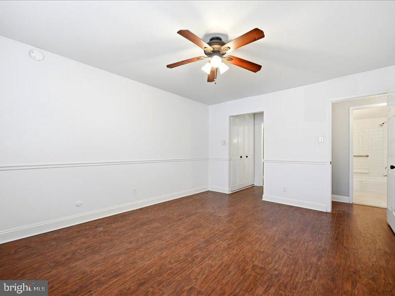 421 Drummers Lane, Unit 421 Wayne, PA 19087 - Photo 23 of 30 an empty room with wooden floor closet and windows