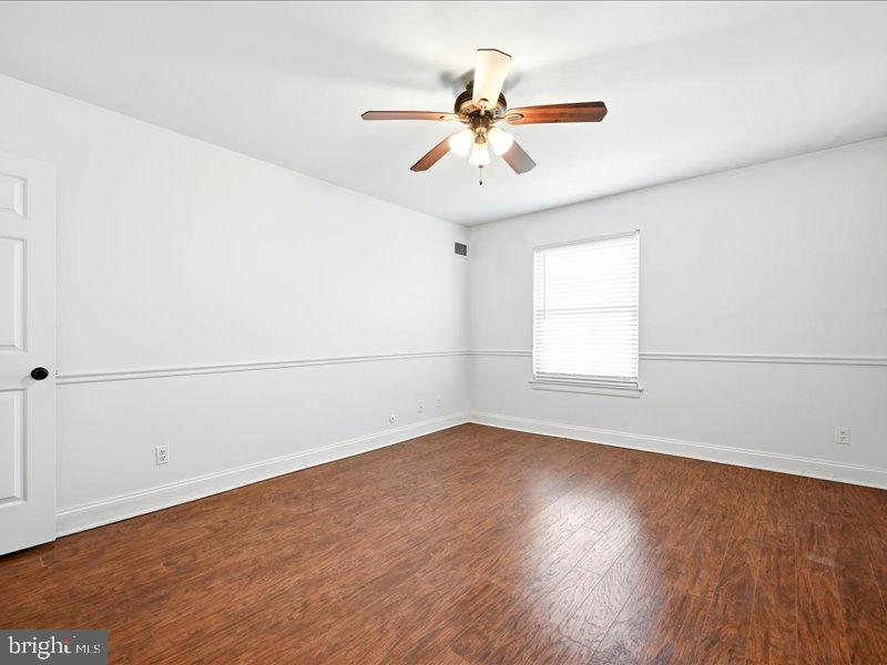 421 Drummers Lane, Unit 421 Wayne, PA 19087 - Photo 24 of 30 an empty room with wooden floor fan and windows