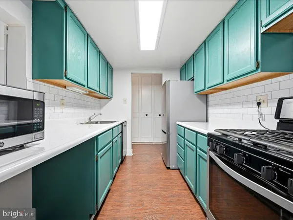 a kitchen with stainless steel appliances and cabinets