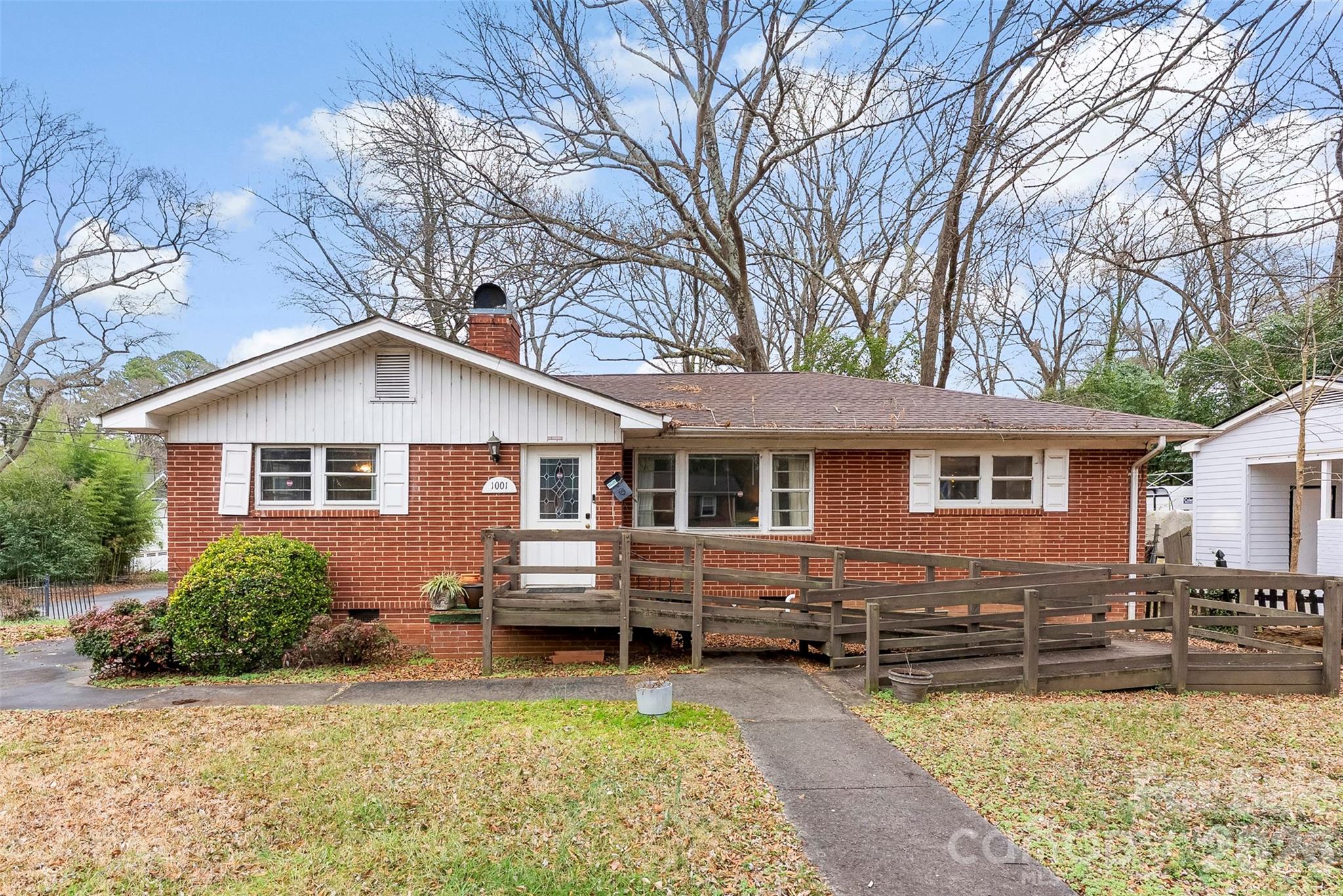 a view of a house with a yard patio and fire pit