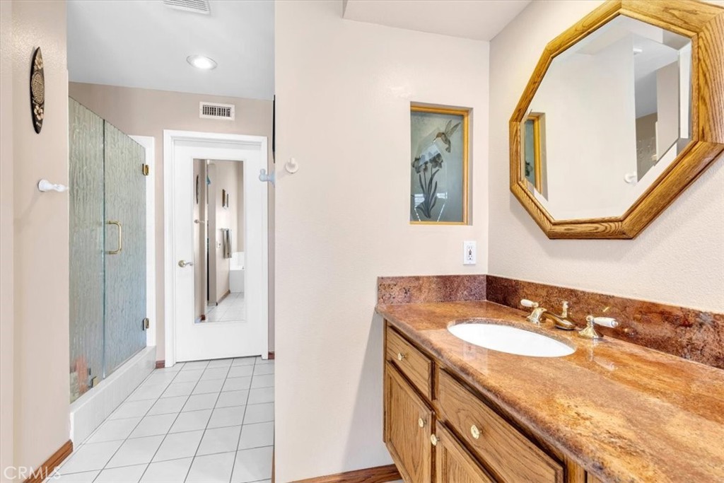 10 St John Dana Point, CA 92629 - Photo 13 of 31 a bathroom with a granite countertop shower sink and mirror