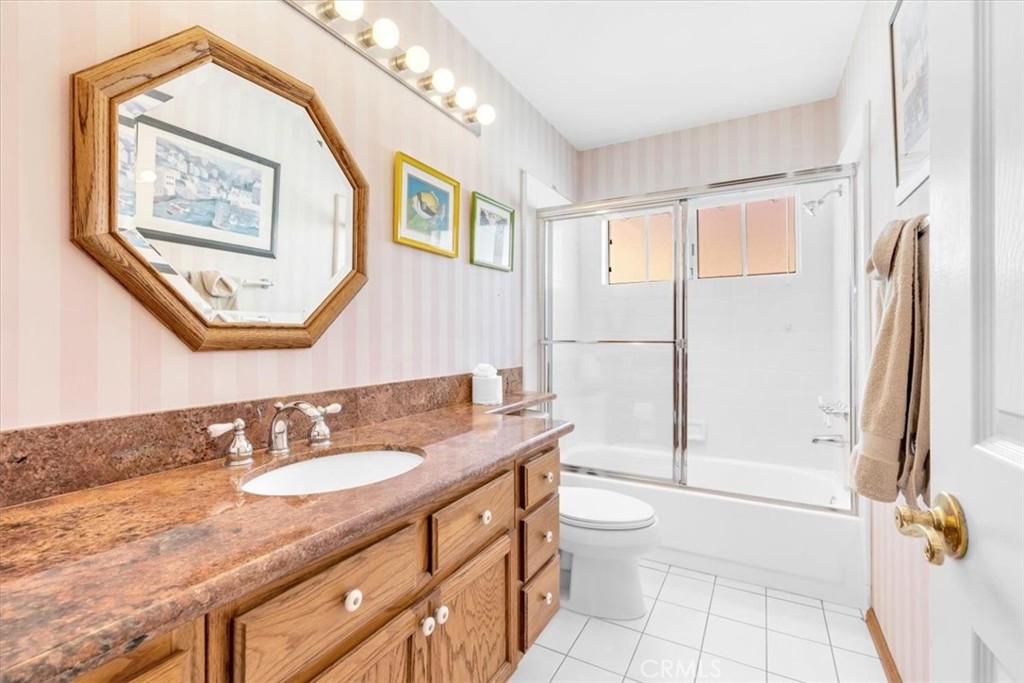 10 St John Dana Point, CA 92629 - Photo 15 of 31 a bathroom with a granite countertop sink toilet and shower