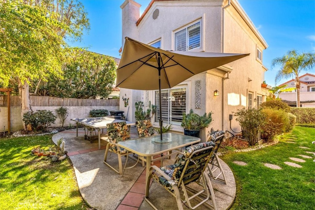 10 St John Dana Point, CA 92629 - Photo 19 of 31 a view of a patio with table and chairs under an umbrella