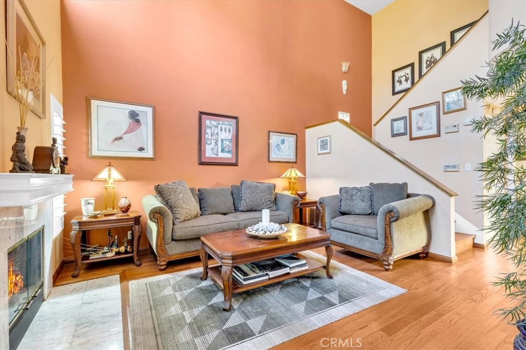 10 St John Dana Point, CA 92629 - Photo 2 of 31 a living room with furniture a fireplace and a large mirror next to a window